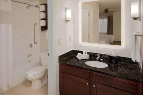 a bathroom with a sink and a toilet and a mirror at Homewood Suites by Hilton Minneapolis-Mall Of America in Bloomington