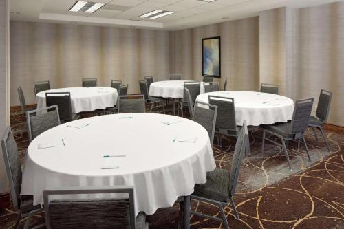 a conference room with white tables and chairs at Homewood Suites by Hilton Minneapolis-Mall Of America in Bloomington