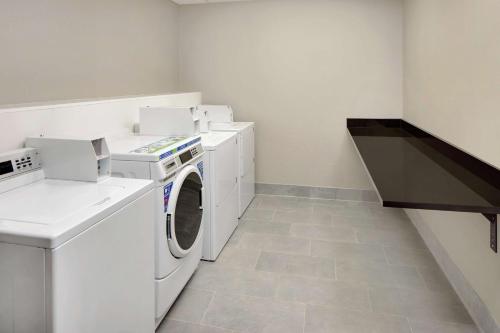 a laundry room with a washer and dryer at Homewood Suites by Hilton Minneapolis-Mall Of America in Bloomington