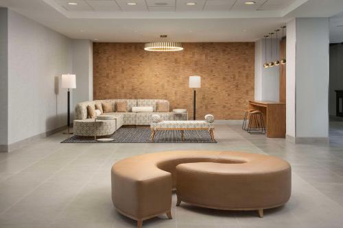 a lobby with a couch and a table at Embassy Suites by Hilton Dulles North Loudoun in Ashburn