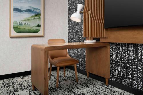 a desk with a chair in a room at Embassy Suites by Hilton Dulles North Loudoun in Ashburn