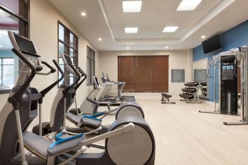 a gym with treadmills and ellipticals in a room at Embassy Suites by Hilton Atlanta NE Gwinnett Sugarloaf in Duluth