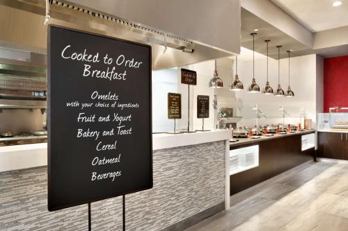 a sign in front of a kitchen with a counter at Embassy Suites by Hilton Atlanta NE Gwinnett Sugarloaf in Duluth