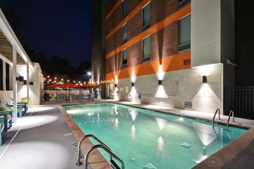 a swimming pool in front of a building at night at Home2 Suites By Hilton Atlanta Lithia Springs in Lithia Springs
