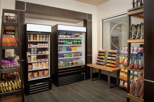 a store aisle with two large refrigerators at Embassy Suites by Hilton Birmingham Hoover in Hoover