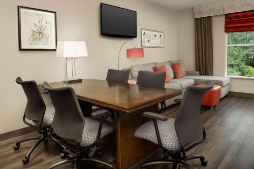 a living room with a table and chairs and a couch at Embassy Suites by Hilton Birmingham Hoover in Hoover