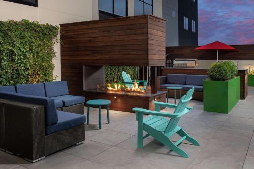 a patio with chairs and a fireplace in a building at Home2 Suites By Hilton Nashville Downtown Convention Center in Nashville