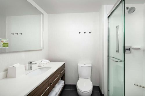 a bathroom with a toilet and a sink and a shower at Home2 Suites By Hilton Nashville Downtown Convention Center in Nashville