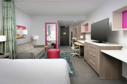 a hotel room with a bed and a living room at Home2 Suites By Hilton Nashville Downtown Convention Center in Nashville
