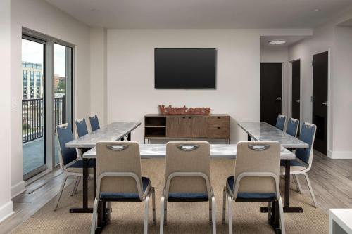 a dining room with a table and chairs and a television at Home2 Suites By Hilton Nashville Downtown Convention Center in Nashville