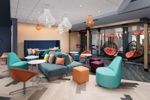 a waiting room with a couch and chairs and tables at Tru By Hilton Murfreesboro, Tn in Murfreesboro