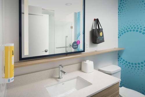 a bathroom with a sink and a mirror at Tru By Hilton Murfreesboro, Tn in Murfreesboro