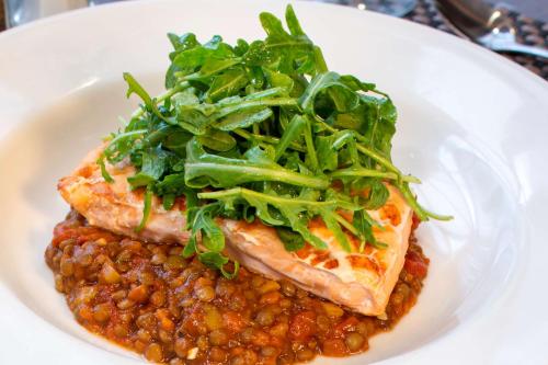 a plate of food with meat and beans and greens at DoubleTree by Hilton Hotel Largo Washington DC in Largo