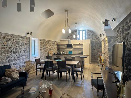 a living room with a table and chairs at ENGLEZENA'S GUESTHOUSE in Leonidion