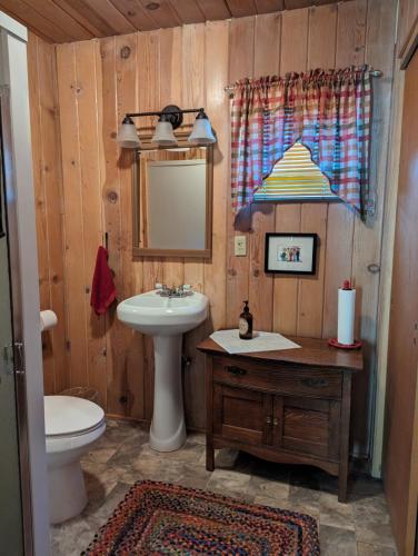 a bathroom with a sink and a toilet at Moore's Cabin in Miramonte