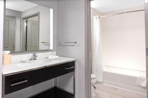 a bathroom with a sink and a toilet and a mirror at Homewood Suites By Hilton Largo Washington Dc in Largo