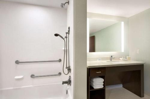 a bathroom with a shower and a sink at Homewood Suites Mobile in Mobile