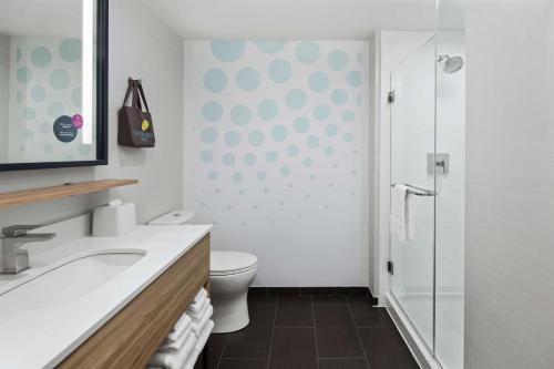 a bathroom with a toilet and a glass shower at Tru By Hilton Savannah Midtown Ga in Savannah