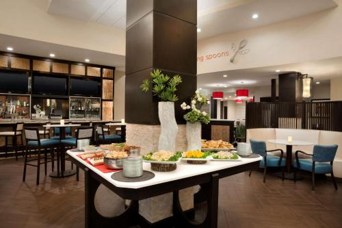 a buffet table with food on it in a restaurant at Embassy Suites by Hilton Jackson North Ridgeland in Ridgeland