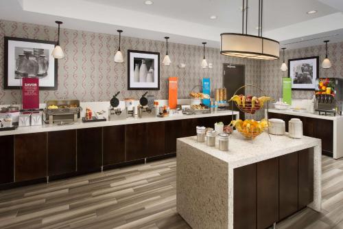a restaurant with a buffet line with fruit on the counter at Hampton Inn Louisville East Hurstbourne in Louisville
