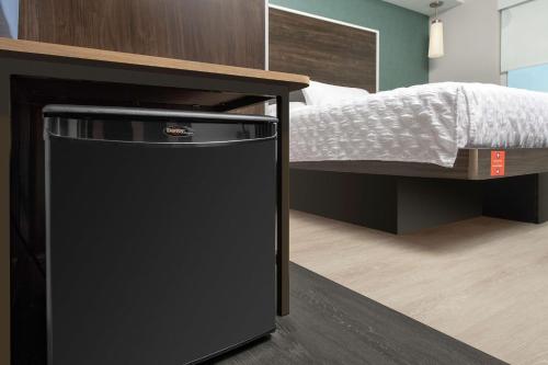 a black trash can in a bedroom next to a bed at Tru By Hilton Louisville East Ky in Louisville