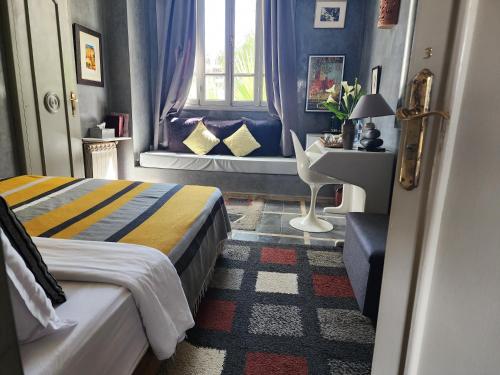 a hotel room with two beds and a window at La Maison de Tanger in Tangier