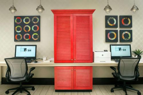 an office with red doors and a desk with two computers at Home2 Suites by Hilton Louisville East Hurstbourne in Louisville