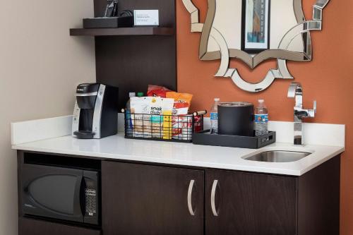 a kitchen counter with a sink and a microwave at Embassy Suites by Hilton Knoxville West in Knoxville