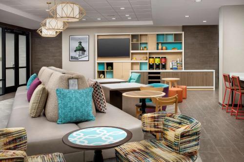 a waiting room with a couch and chairs at Home2 Suites By Hilton Columbia Southeast Fort Jackson in Columbia