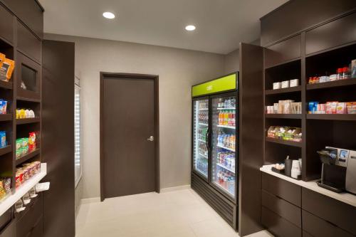 a grocery store aisle with a large refrigerator at Home2 Suites By Hilton Birmingham Downtown in Birmingham