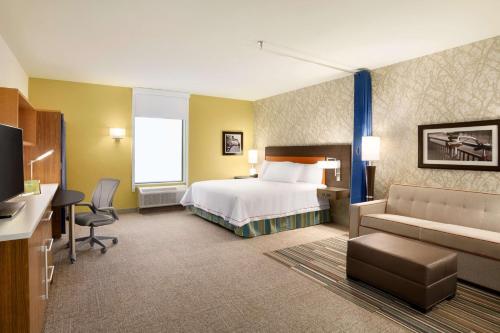 a large hotel room with a bed and a desk at Home2 Suites By Hilton Birmingham Downtown in Birmingham