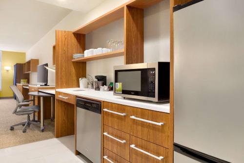 a kitchen with a counter top with a microwave at Home2 Suites By Hilton Birmingham Downtown in Birmingham