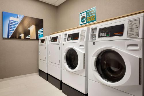 a row of washing machines in a laundry room at Home2 Suites By Hilton Birmingham Downtown in Birmingham