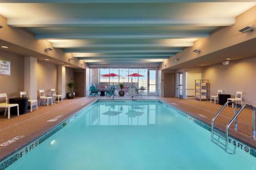 a pool with blue water in a hotel room at Home2 Suites by Hilton Baltimore/Aberdeen MD in Aberdeen