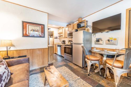 a kitchen with a table and a dining room at Meticulously Updated Unit With Lots of Thoughtful Upgrades Ski In, Walk to Town PM1B in Breckenridge