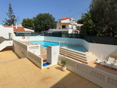 a swimming pool on the roof of a house at Host Wise - Lively Charming Apartment w Pool in Praia do Carvoeiro