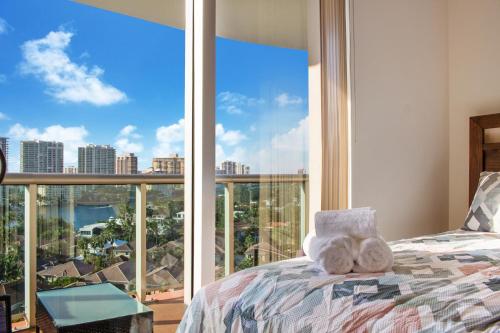 a bedroom with a bed and a large window at Family Beach Home w Ocean & Bay Views - Upgraded Corner Unit in Miami Beach