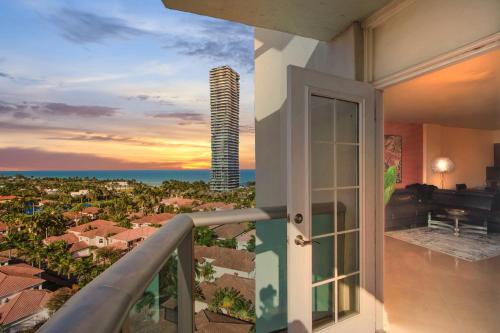 a balcony with a view of a city at Family Beach Home w Ocean & Bay Views - Upgraded Corner Unit in Miami Beach