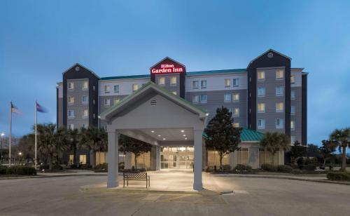 a hotel building with a bench in front of it at Hilton Garden Inn Lafayette/Cajundome in Lafayette