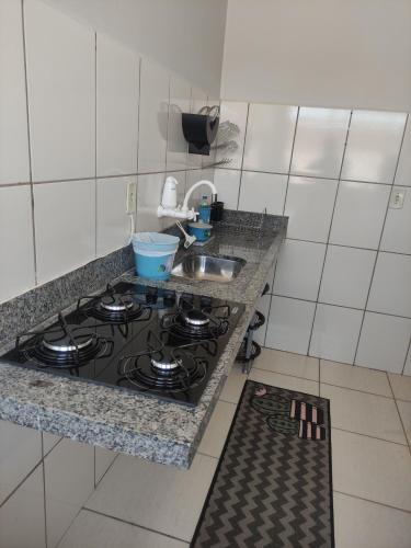 a kitchen with a stove and a counter top at Apto Recanto Aconchego (B-E 32) in Rio Verde