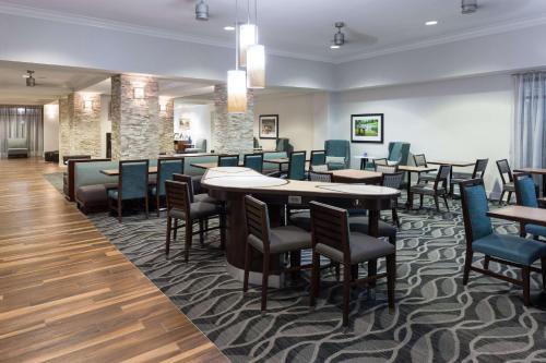 a restaurant with tables and chairs in a room at Homewood Suites by Hilton Huntsville-Village of Providence in Huntsville
