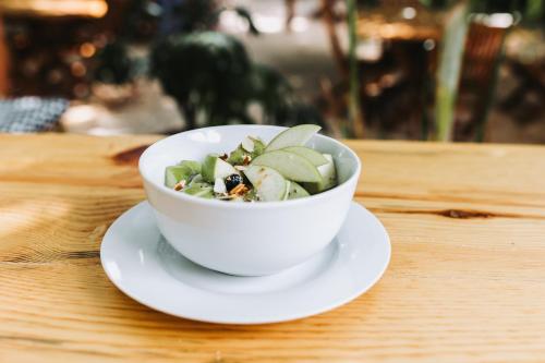 a white bowl of food on a plate on a table at Hotel Casa Barbara Holbox in Holbox Island