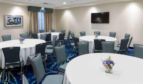 a conference room with white tables and chairs at Homewood Suites by Hilton Cape Canaveral-Cocoa Beach in Cape Canaveral