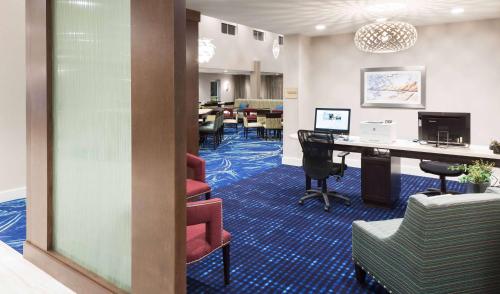 an office with a desk and chairs and a table at Homewood Suites by Hilton Cape Canaveral-Cocoa Beach in Cape Canaveral