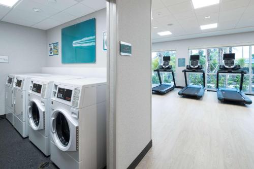 a laundry room with machines and a row of windows at Hampton Inn & Suites Cape Canaveral Cruise Port, Fl in Cape Canaveral