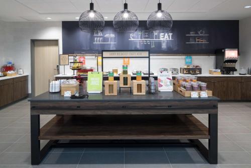 a large table in a store with food on it at Hampton Inn & Suites Cape Canaveral Cruise Port, Fl in Cape Canaveral