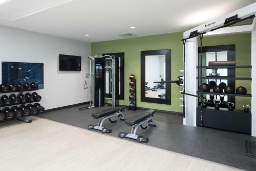 a gym with dumbbells and weights in a room at Hampton Inn & Suites Cape Canaveral Cruise Port, Fl in Cape Canaveral
