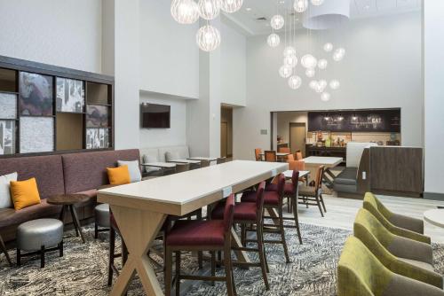 a dining room with a long table and chairs at Hampton Inn & Suites Cape Canaveral Cruise Port, Fl in Cape Canaveral