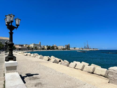 a street light next to a body of water at Santa Scolastica Home in Bari
