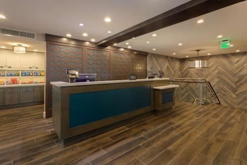 a lobby with a bar with a blue counter at Homewood Suites by Hilton St Augustine San Sebastian in Saint Augustine